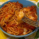 Shrimp Marinara in blue bowl on a lemon tablecloth